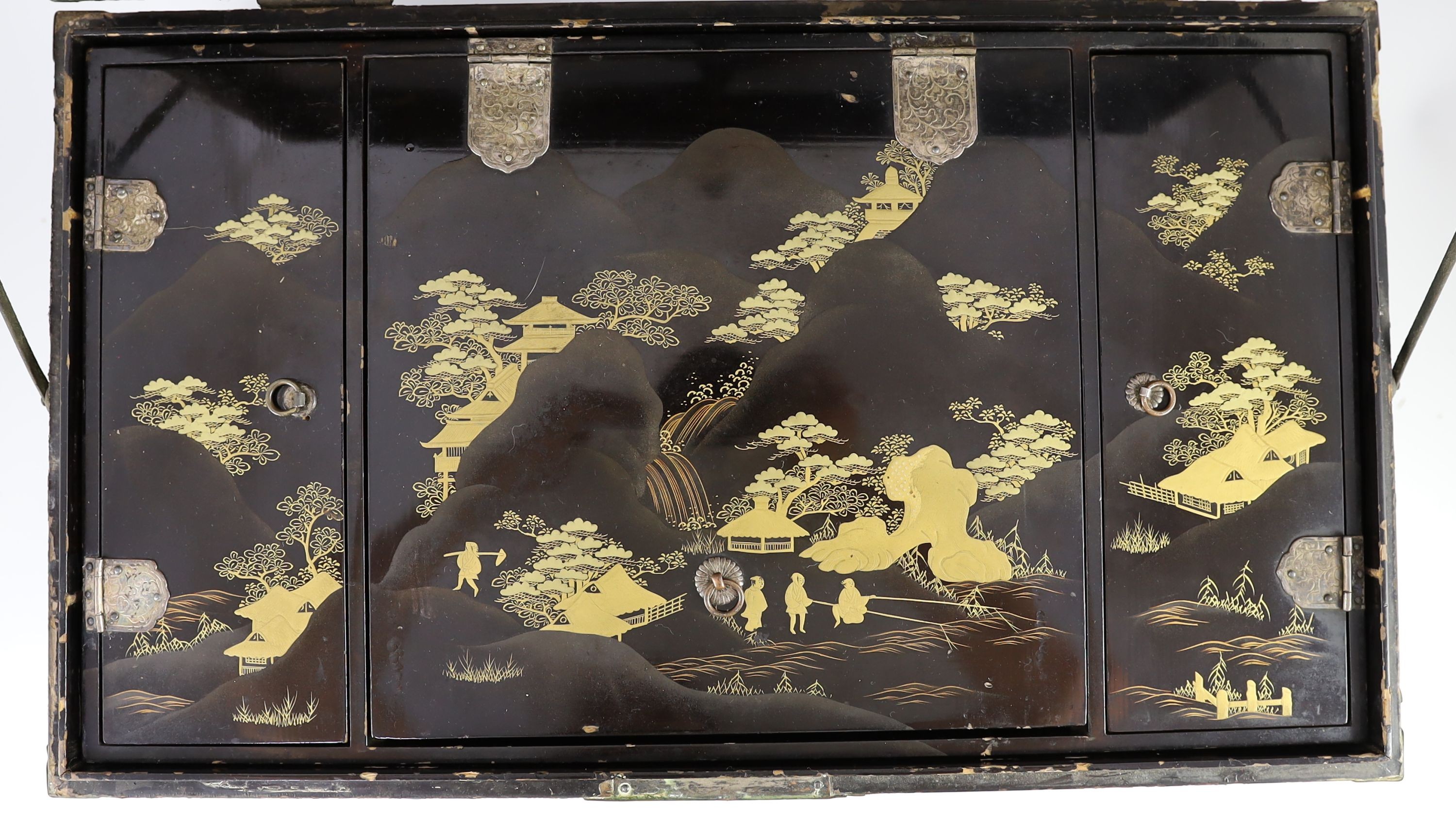 A Japanese lacquer fitted travelling trunk, 19th century, 55cm wide, H 23cm. D 32cm. Some losses to lacquer and wear to mounts